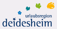 Logo der Urlaubsregion Deidesheim mit stilisierten Pflanzenmotiven in Blau, Gr&uuml;n und Gelb.